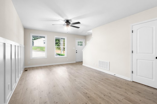 unfurnished living room featuring visible vents, ceiling fan, baseboards, and light wood-style floors