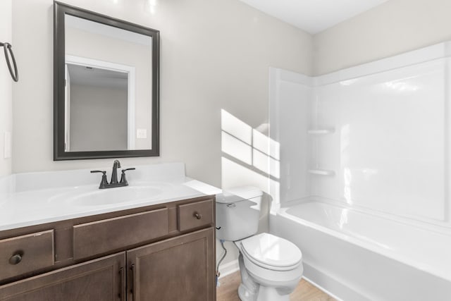 full bathroom featuring vanity,  shower combination, toilet, and wood finished floors