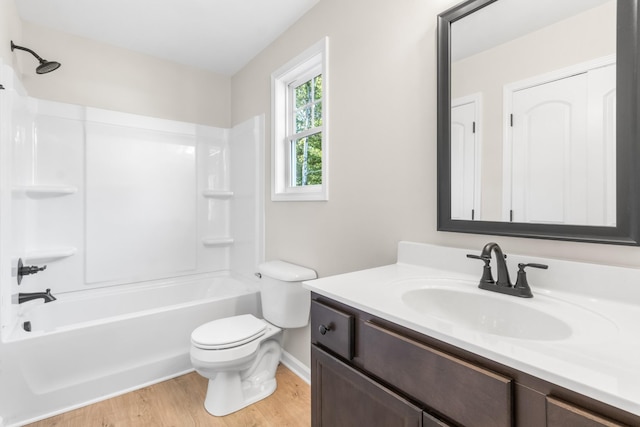 full bath with shower / bath combination, toilet, vanity, and wood finished floors