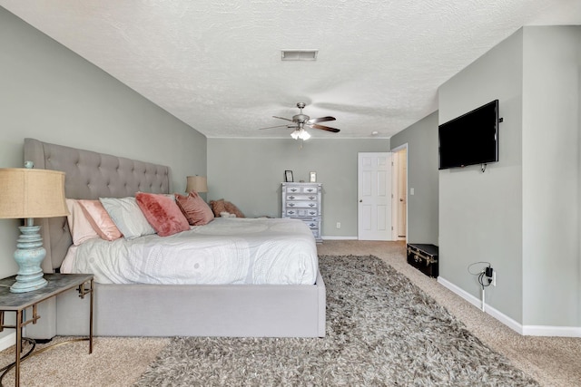 carpeted bedroom with baseboards, visible vents, and a textured ceiling