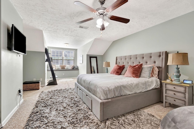 bedroom featuring baseboards, visible vents, vaulted ceiling, a textured ceiling, and carpet flooring