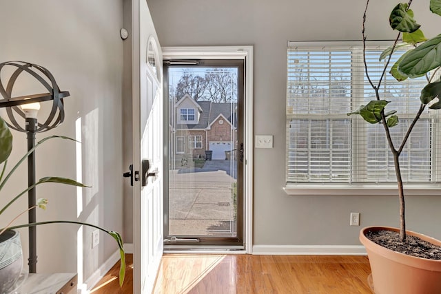 entryway featuring wood finished floors, baseboards, and french doors