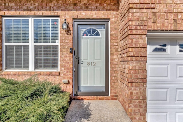 doorway to property with brick siding