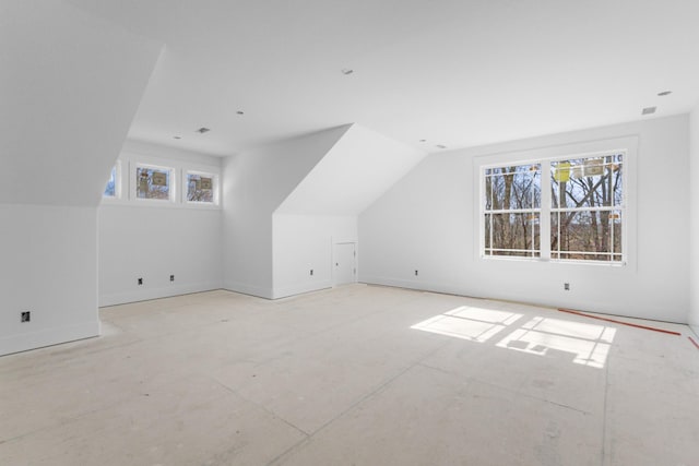 additional living space featuring vaulted ceiling