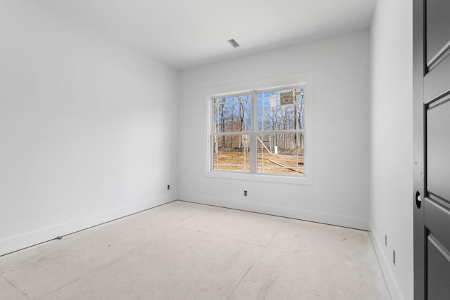 empty room featuring baseboards and visible vents