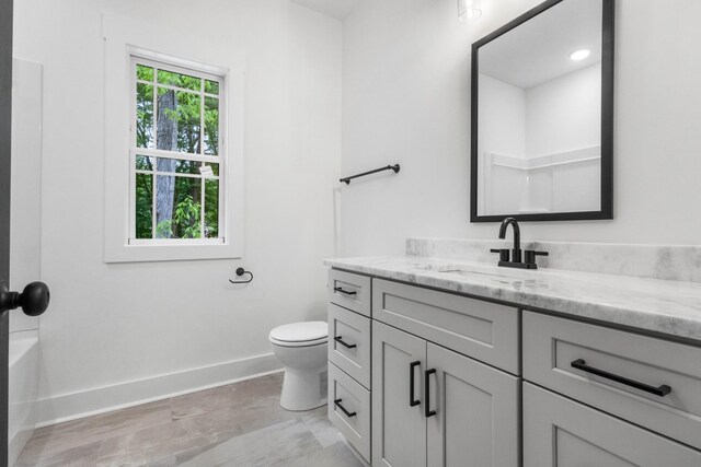 4410 Shiloh Canaan Rd, Palmyra, TN 37142 - bathroom with baseboards, toilet, and vanity