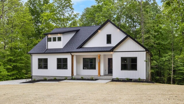 4410 Shiloh Canaan Rd, Palmyra, TN 37142 - modern inspired farmhouse featuring covered porch and a shingled roof