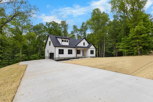 4410 Shiloh Canaan Rd, Palmyra, TN 37142 - modern farmhouse with an attached garage and driveway