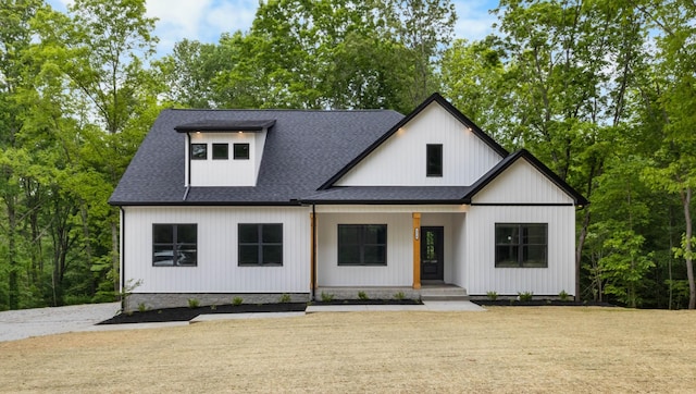 4410 Shiloh Canaan Rd, Palmyra, TN 37142 - modern inspired farmhouse with a porch and a shingled roof