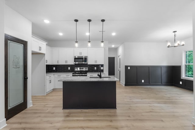 4410 Shiloh Canaan Rd, Palmyra, TN 37142 - kitchen featuring appliances with stainless steel finishes, a sink, white cabinets, backsplash, and recessed lighting
