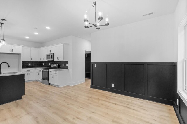 4410 Shiloh Canaan Rd, Palmyra, TN 37142 - kitchen with stainless steel appliances, a sink, a chandelier, tasteful backsplash, and light countertops