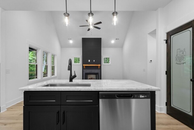 4410 Shiloh Canaan Rd, Palmyra, TN 37142 - kitchen with stainless steel dishwasher, a sink, vaulted ceiling, dark cabinets, and light wood-style floors
