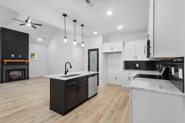 4410 Shiloh Canaan Rd, Palmyra, TN 37142 - kitchen featuring stainless steel dishwasher, electric stove, a sink, a ceiling fan, and white cabinetry