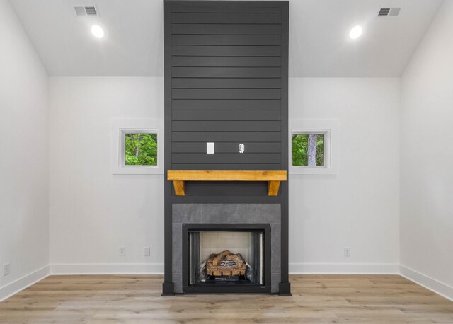 4410 Shiloh Canaan Rd, Palmyra, TN 37142 - unfurnished living room with a fireplace, healthy amount of natural light, wood finished floors, and recessed lighting