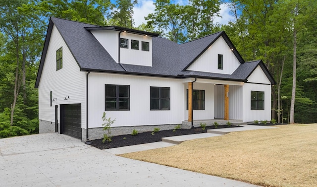 4410 Shiloh Canaan Rd, Palmyra, TN 37142 - modern farmhouse featuring a porch, an attached garage, concrete driveway, and roof with shingles