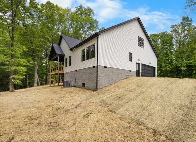 4410 Shiloh Canaan Rd, Palmyra, TN 37142 - view of side of property with crawl space, an attached garage, central air condition unit, driveway, and a deck