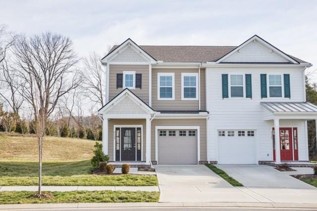 view of front facade featuring a garage, concrete driveway, and a front lawn