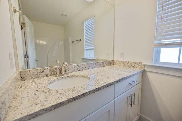 bathroom with vanity and walk in shower