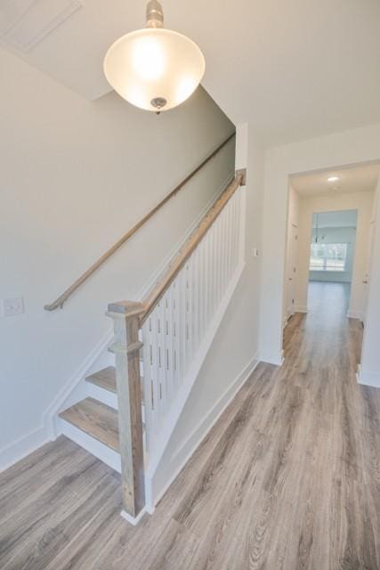 stairs with baseboards and wood finished floors