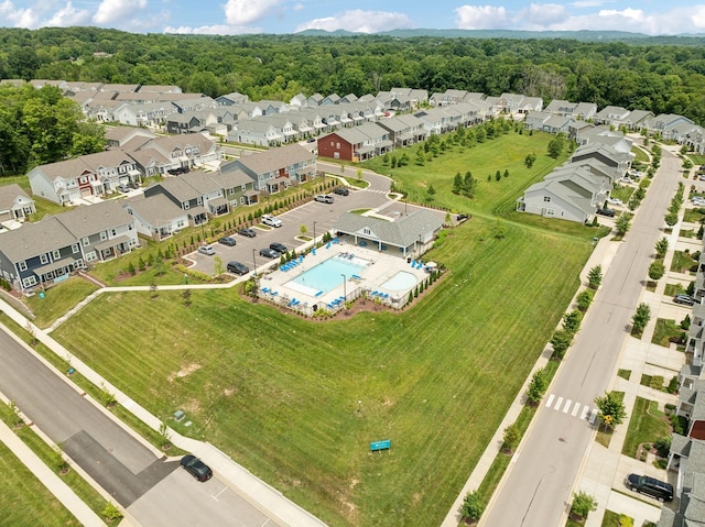 birds eye view of property with a residential view and a wooded view