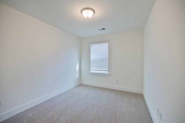 empty room with baseboards and carpet floors