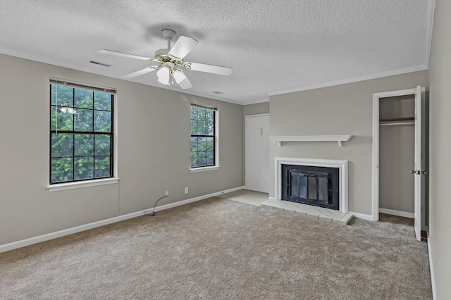 unfurnished living room with visible vents, carpet floors, a fireplace, and crown molding