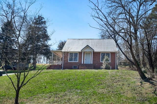 view of front of property with a front lawn, brick siding, and metal roof