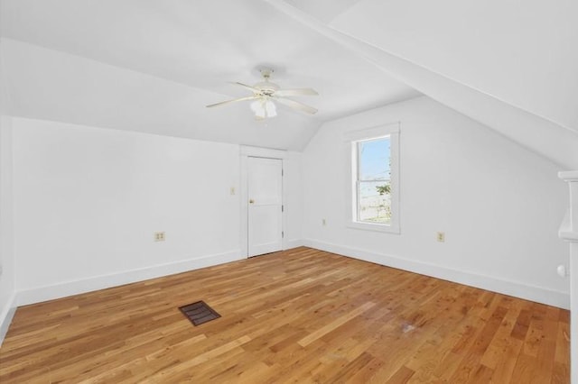 bonus room featuring visible vents, baseboards, lofted ceiling, and light wood-style floors