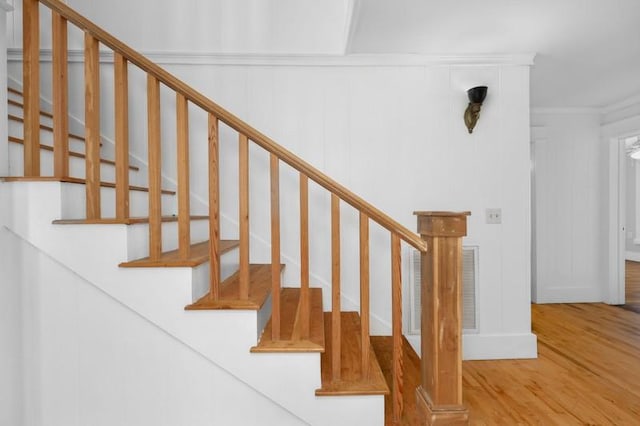 stairs featuring wood finished floors and visible vents