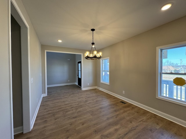 interior space with plenty of natural light, dark wood-type flooring, and baseboards