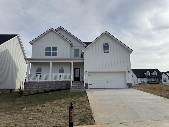 view of front of house with a porch, board and batten siding, and a front yard