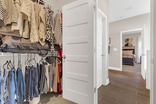 spacious closet featuring wood finish floors and visible vents