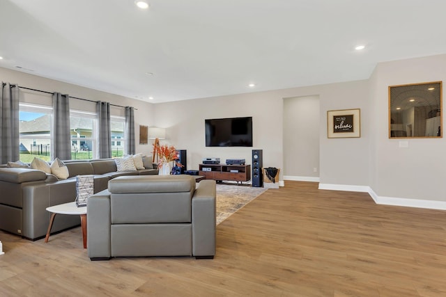 living room with light wood-style flooring, recessed lighting, and baseboards