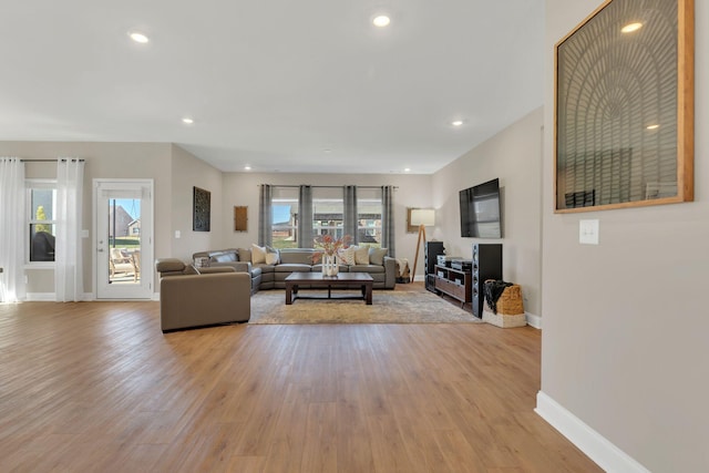 living room featuring recessed lighting, light wood-style floors, and a healthy amount of sunlight