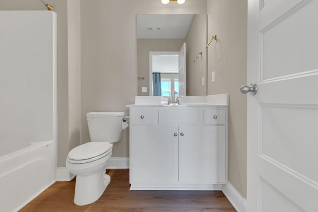 full bathroom with vanity, wood finished floors, visible vents, baseboards, and toilet