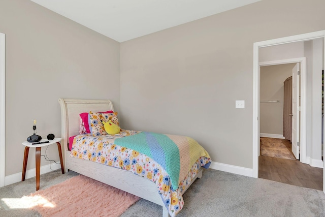 bedroom featuring carpet and baseboards