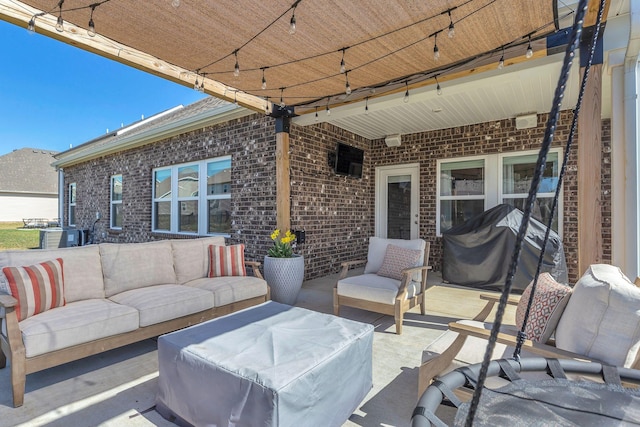 view of patio with an outdoor living space and a grill