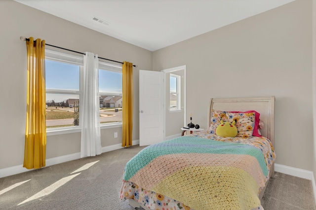 carpeted bedroom featuring visible vents and baseboards