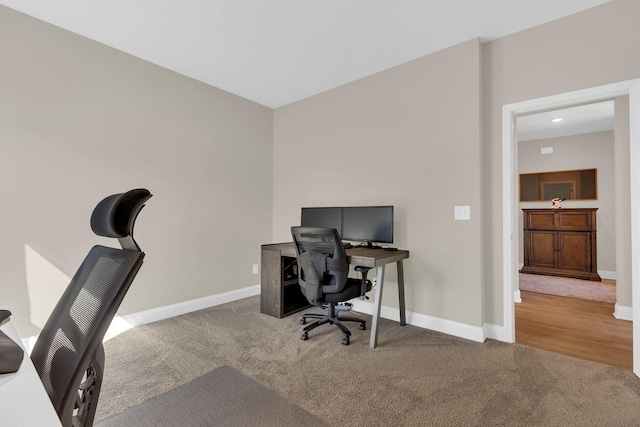 office area featuring baseboards and carpet floors