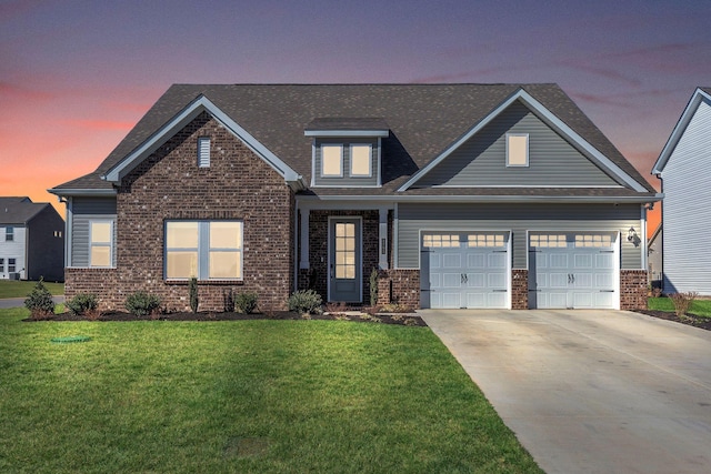 craftsman inspired home featuring an attached garage, a lawn, brick siding, and driveway