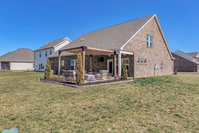 back of property featuring a yard, a patio area, and brick siding