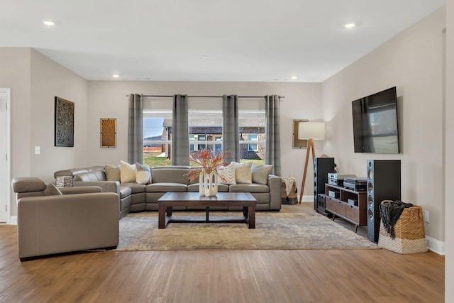 living room featuring recessed lighting, baseboards, and wood finished floors