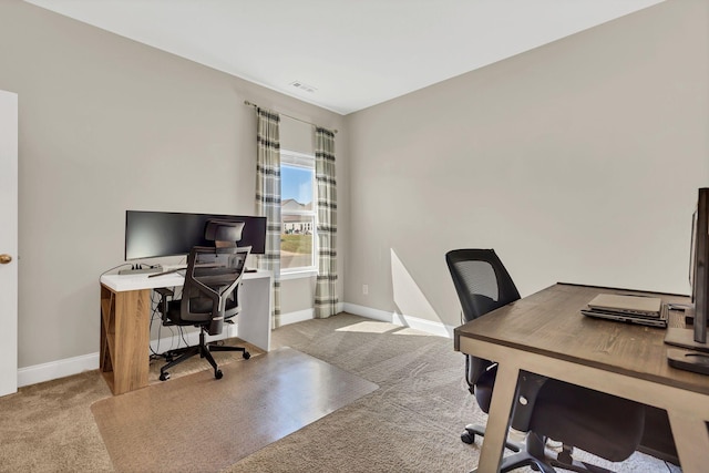 carpeted office space with visible vents and baseboards