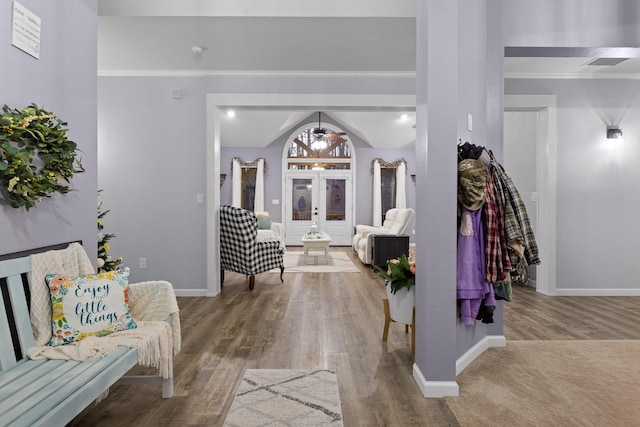 foyer entrance with baseboards and wood finished floors