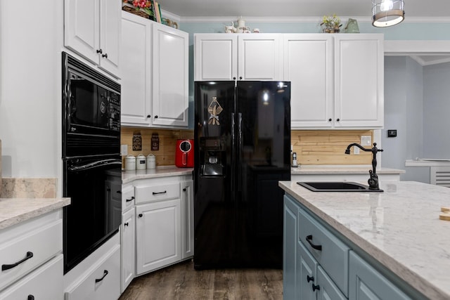 kitchen with black appliances, a sink, dark wood-style floors, white cabinetry, and crown molding