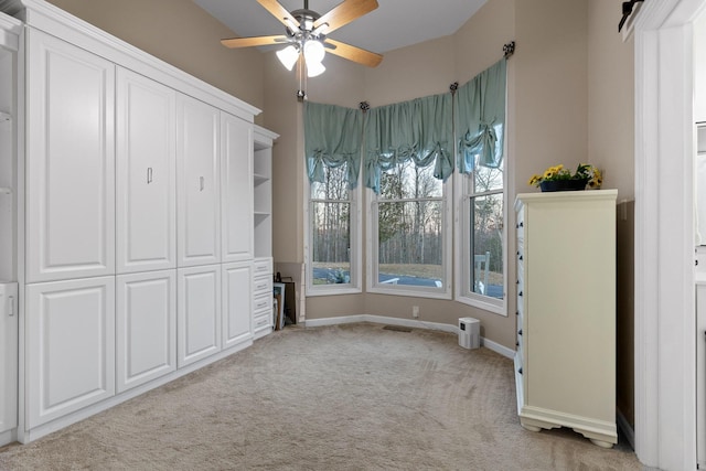 unfurnished bedroom featuring light carpet, visible vents, ceiling fan, and baseboards