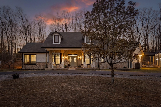 view of front of home with stone siding and covered porch