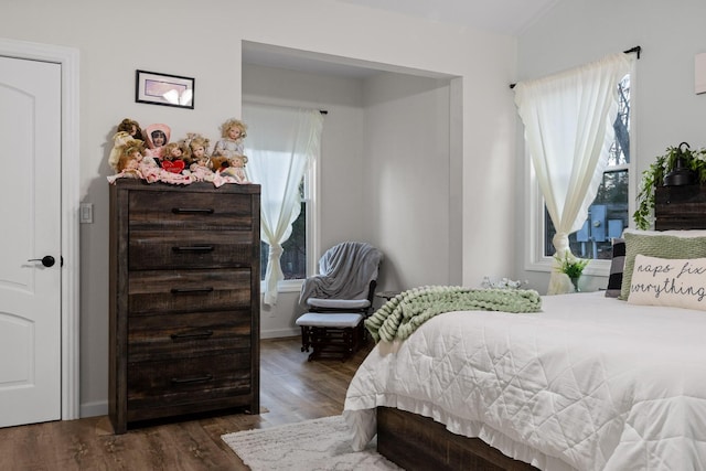 bedroom with dark wood finished floors