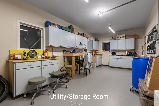 kitchen with concrete floors and white cabinets