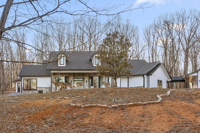 view of front of property with stone siding and a garage